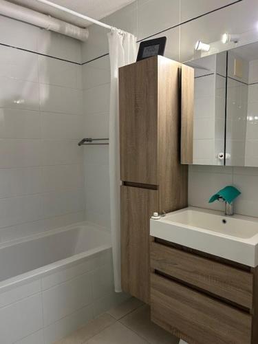 a bathroom with a sink and a bathtub and a sink at Malgré Tout 0207 in Koksijde