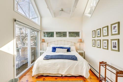 a bedroom with a large bed with blue pillows at Beautiful Berkshires Cottage on Lake Buel in Great Barrington