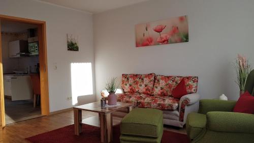 a living room with a couch and a table at Haus Lieberum Ferienwohnung 1.Etage Balkon in Bad Sooden-Allendorf