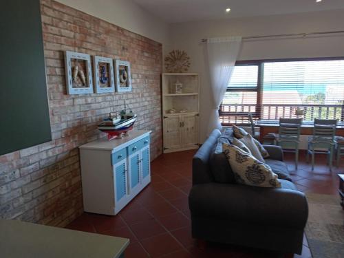 a living room with a couch and a table at LêPlek Guesthouse in Saldanha