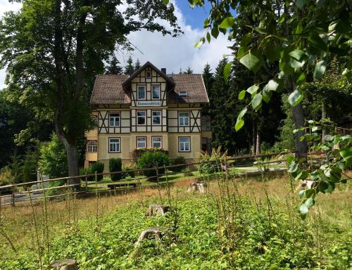 an old house in the middle of a field at Haus Sonnenblick in Benneckenstein
