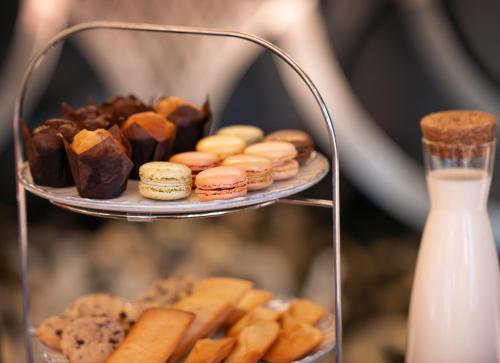 a tray of pastries and cookies on a plate at Juliana Hotel & Spa - Brussels Centre in Brussels