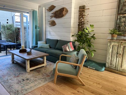 a living room with a couch and a coffee table at The Seahorse Beach House in Egmond aan Zee