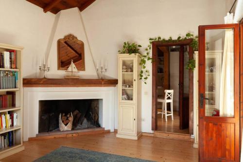a living room with a fireplace and a mirror at Casa Vacanze Mar Bea in Terra Mala
