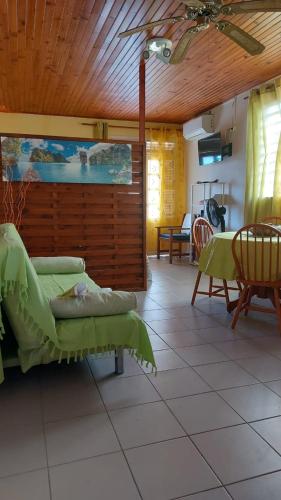 a living room with a couch and a table at Studio La villa du Manguier in Le Vauclin