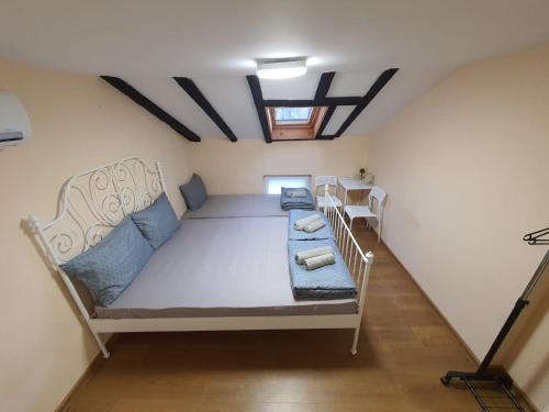 a bedroom with a large bed with two chairs at Kapana Stay at Center Plovdiv in Plovdiv