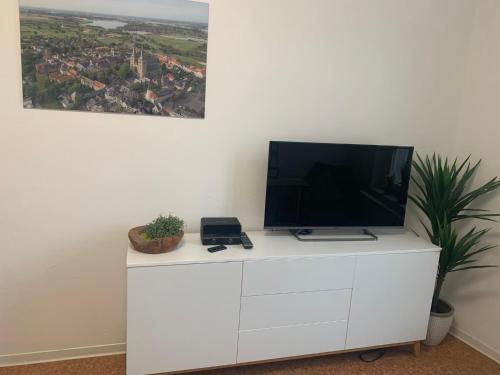 a tv on top of a white dresser at Altes Forstamt in Xanten