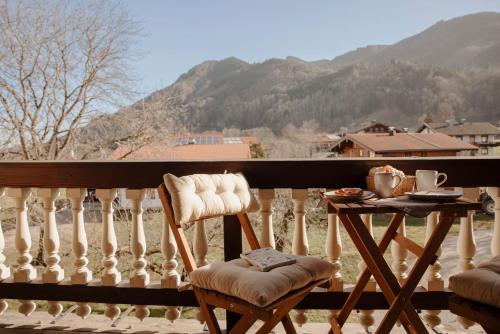 a table and chairs on a balcony with a view at Staudingerhof in Staudach-Egerndach