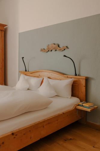 a bedroom with a bed with white sheets and pillows at Staudingerhof in Staudach-Egerndach