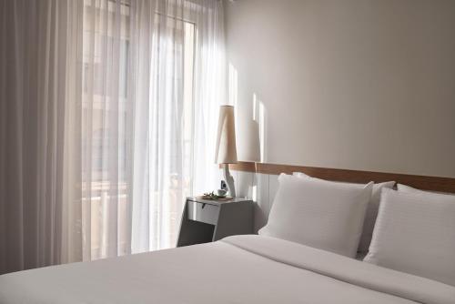 Postel nebo postele na pokoji v ubytování Lato Boutique Hotel