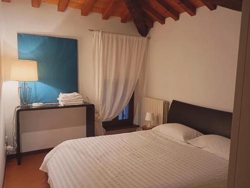 ein Schlafzimmer mit einem weißen Bett und einem Fenster in der Unterkunft La Finestra Sul Civico Cinque in Verona