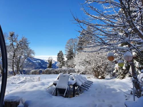 a picnic table covered in snow in a yard at Magnifique Chalet Valérie 5 chambres à coucher & vue unique in Gryon
