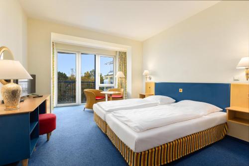 Ένα ή περισσότερα κρεβάτια σε δωμάτιο στο IFA Rügen Hotel & Ferienpark