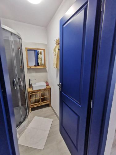 a blue door in a bathroom with a shower at New House La Nea Paul in Maliuc