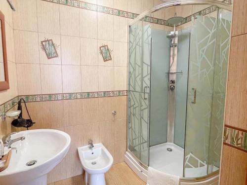 a bathroom with a shower and a sink and a toilet at Laguna in Slavske