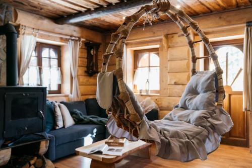 a swing hanging from a ceiling in a living room at Mountain Shelter by Loft Affair in Zakopane