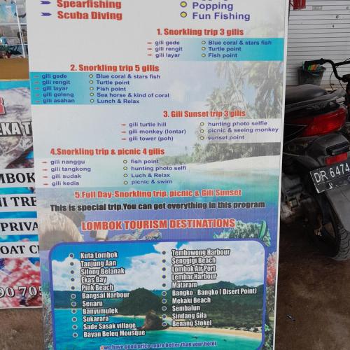 a sign for a restaurant with a price list at Mango Homestay in Sekotong