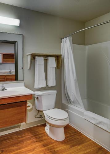 a bathroom with a toilet and a shower and a sink at WoodSpring Suites Chesapeake-Norfolk South in Chesapeake