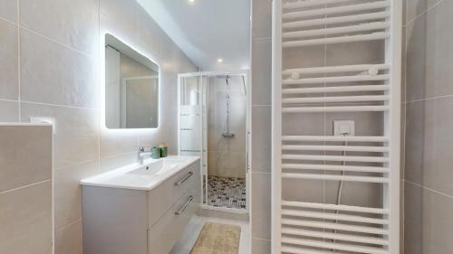 a white bathroom with a sink and a shower at Sunny City Center in Nice