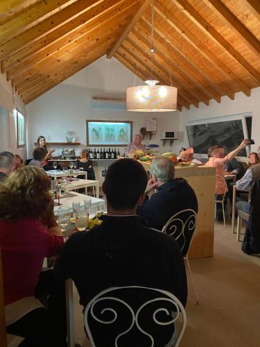 a group of people sitting at a table in a restaurant at Entre Vinhas & Mar in Óbidos