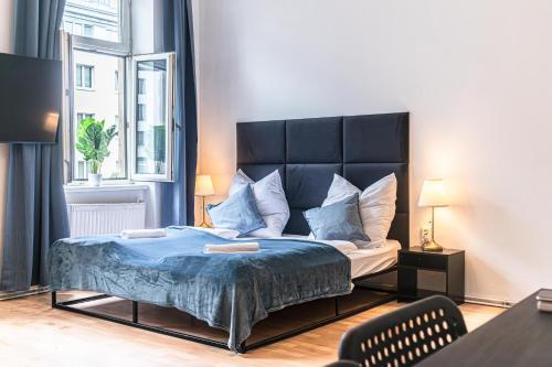 a bedroom with a large bed with a blue blanket at Pleasant 2BR Apt- Near Train Station Hetzendorf in Vienna