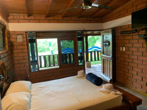 Una cama o camas en una habitación de Hotel Tekal del Rio