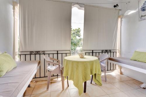 a small room with a table and chairs and a bed at Flo Villa in La Gaulette