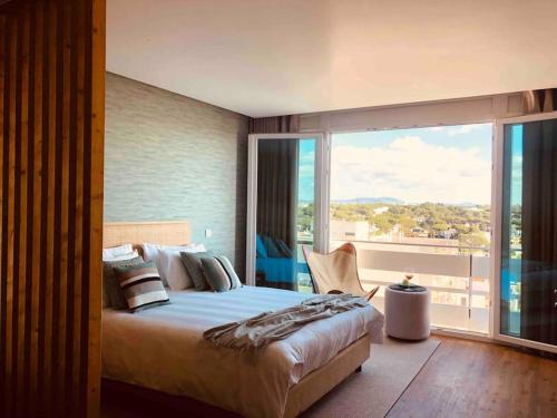 a bedroom with a large bed and a large window at Vilamoura Sunrise in Quarteira