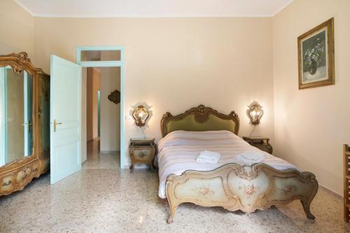 a bedroom with a large bed in a room at Appartamento in Villa La Baronessa in Sanremo