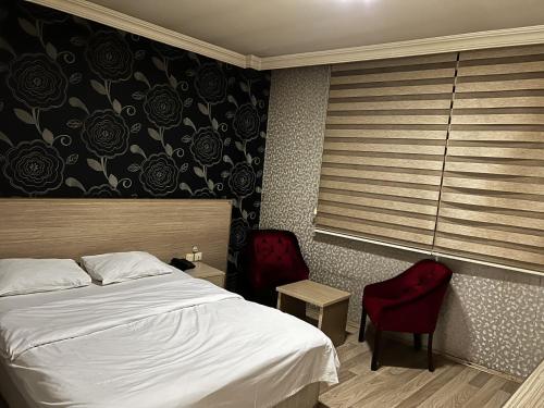 Ένα ή περισσότερα κρεβάτια σε δωμάτιο στο Otel Madi