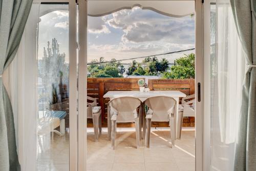 a dining room with a table and a glass door at Flo Villa in La Gaulette