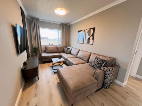 a living room with a couch and a table at Garður Apartments in Gardur