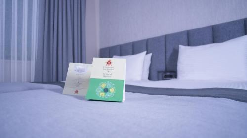 two books are sitting on top of a bed at Dosso Dossi Hotels Old City in Istanbul