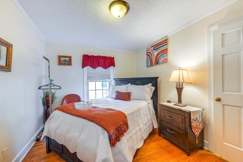 a bedroom with a bed and a dresser and a window at Greenville Home 2 Mi to Downtown! in Greenville