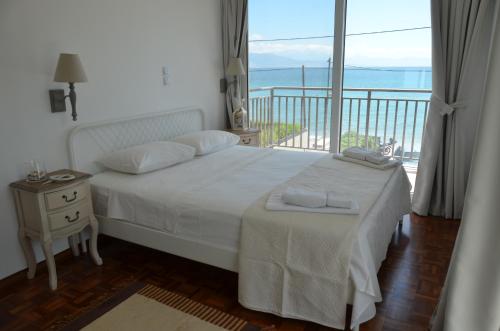a bedroom with a bed with a view of the ocean at Maison de la mer in Témeni