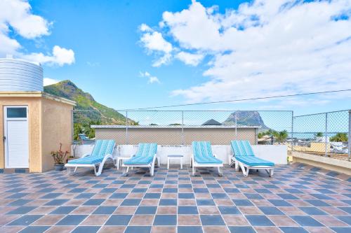 a group of chairs and a table on a patio at Flo Villa in La Gaulette