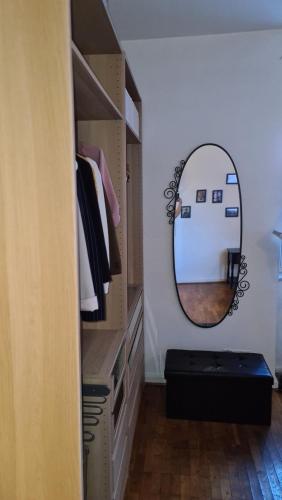 a dressing room with a mirror and a dresser at Gemütliches Zimmer in einer Altbauwohnung in der Stadt in Würzburg