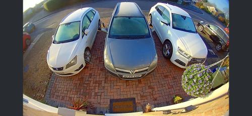 three cars parked on top of a brick wall at 5 bedroom detached house sleeps 13 spacious Parking 5 mins driving to Bicester Village in Bicester