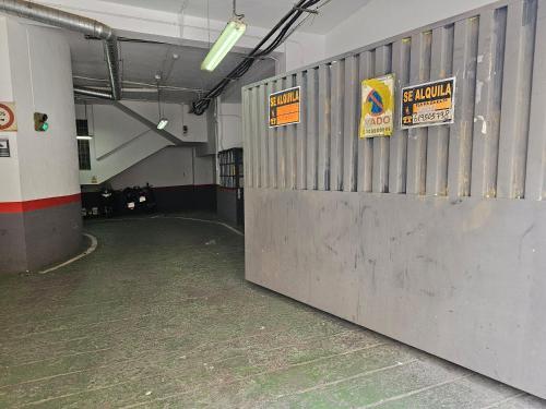 an empty parking garage with signs on the wall at HR-Madrid-Puerta del Sol in Madrid