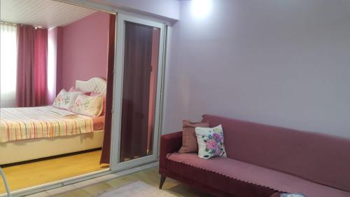 a living room with a couch and a bedroom at Samlife Apart in Samsun