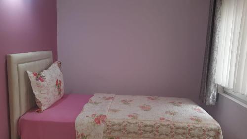 a small bedroom with a bed and a pillow at Samlife Apart in Samsun