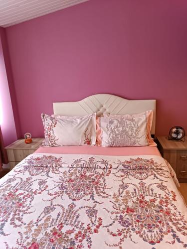 a bedroom with a bed with a purple wall at Samlife Apart in Samsun