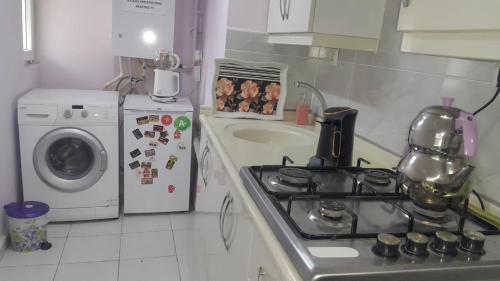 a kitchen with a stove top oven next to a sink at Samlife Apart in Samsun