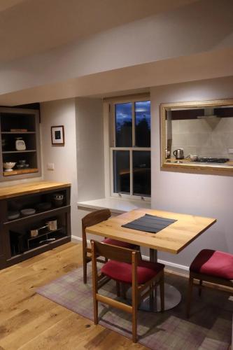 a dining room with a table and chairs and a window at Unique Highland in Inverness