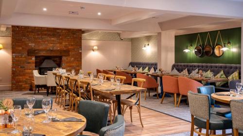 a restaurant with tables and chairs and a fireplace at 127cs HOBURNE NAISH HOLIDAY PARK in Highcliffe