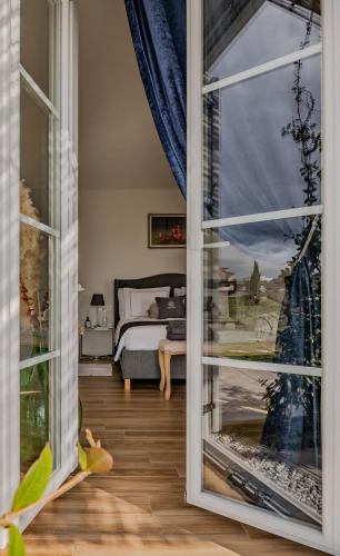 a bedroom with a view of a bed through a window at Peterc Vineyard Estate in Kojsko