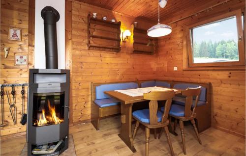 a dining room with a fireplace and a table and chairs at Ferienhaus In Sagerberg in Sagerberg