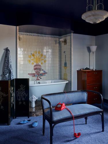 a living room with a chair and a tub at Hotel Ulysses, a Member of Design Hotels in Baltimore