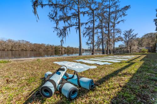 a row of binoculars laying on the grass next to a river at Suwannee Gables in Old Town