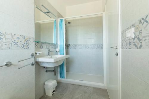 a bathroom with a sink and a shower at Camping Villaggio Il Frutteto in Cupra Marittima